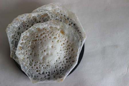 Laced Rice Crepes or Fermented rice pancakes made with fermented rice batter and coconut milk. A...