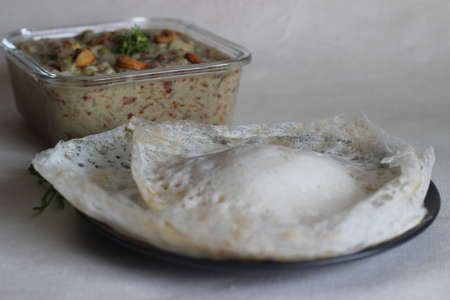 Fermented rice pancakes made with fermented rice batter and coconut milk served along with mixed vegetable ground coconut cashew gravy. Favourite of South Indians, known as Appam vegetable kurmaの写真素材