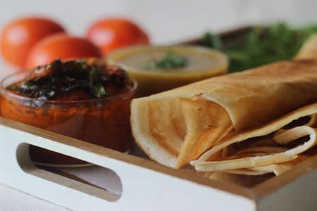 Crispy pancake made of rice and lentils. Served with tomato chilly condiment and sambar. Shot on...