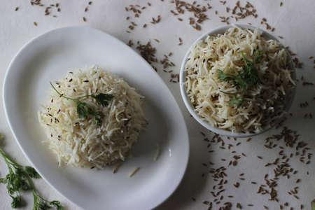 Indian rice dish made of basmati rice flavoured with cumin seeds and spices. Locally known as jeera rice. Shot on white background.の写真素材