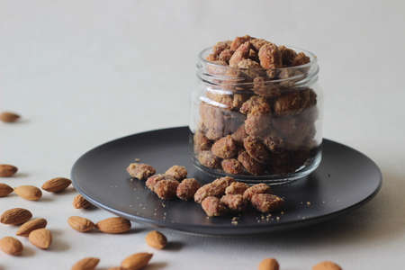 Candied almonds that are crunchy and golden brown. Shot on white background.の写真素材