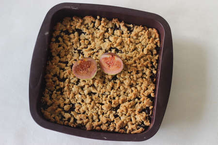 Home-baked Fig crumbles inside silicon bake dish. Shot on white background.の写真素材