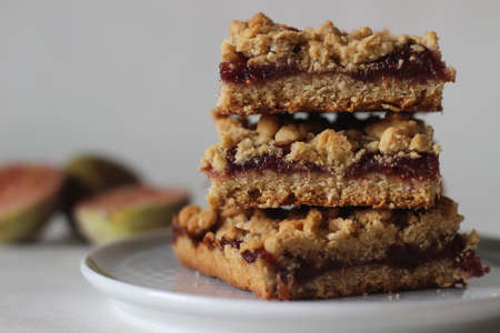 Home-baked Fig crumble bars made of fresh figs and whole wheat flour. Shot on white background.の写真素材