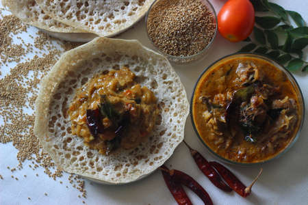 kodo millet hoppers prepared with a batter of kodo millet, flattened rice and coconut fermented with...
