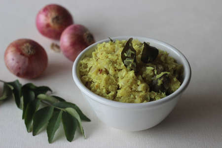 Stir fried onions with grated coconut, green chillies and curry leaves. A tasty side dish for Kerala meals. Shot on white background.の写真素材