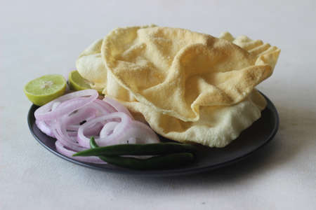 A papadum also called papad is a thin, crisp, round flatbread from India. It is made by deep frying...