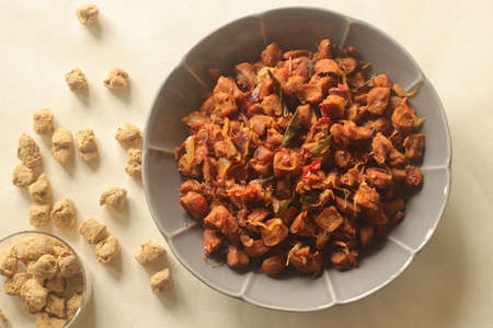 Dry roasted soya chunks with onions tomatoes and spices. Prepared with Kerala style meat masala in coconut oil. Shot on white backgroundの写真素材