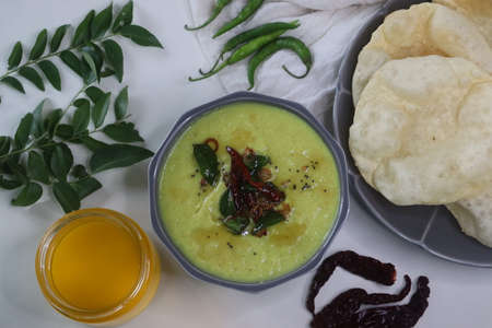 Parippu curry, The first course of Kerala Sadya. Boiled moong dal cooked with coconut, green chilli,...