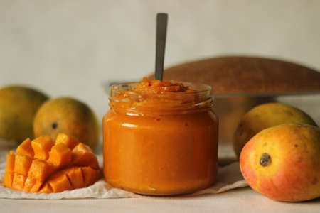 Home made alphonso mango jam with 3 ingredients. Mango pulp, sugar and lime juice. Alphonso mango is widely considered to be the tastiest in India. Shot with a wheat bread in the backgroundの写真素材