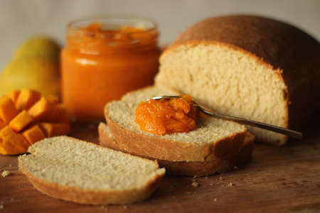 Slice of home baked wheat bread with a spread of home made alphonso mango jam. It is a 3 ingredient jam with mango pulp, sugar and lime juice. Alphonso is the tastiest mango in Indiaの写真素材