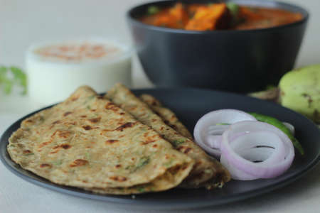 Bottle Gourd Flatbread served with cottage cheese masala. Indian flat bread made of whole wheat flour, grated bottle gourd and spices. Popularly known as Lauki Ka Paratha and paneer masala in India.の写真素材