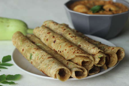 Indian flat bread made of whole wheat flour, grated bottle guard, yogurt and spices served with...