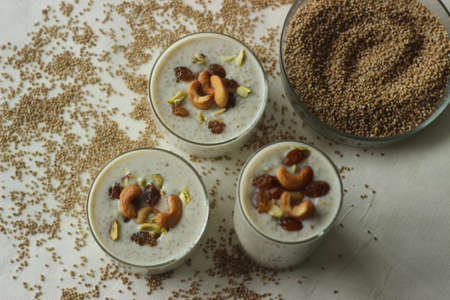 Kodo millet pudding. Rich creamy sweet dessert garnished with ghee roasted raisins and nuts. An...