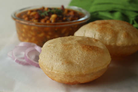 Whole wheat puris served with black eyed beans or cowpea beans gravy as side dish. The gravy is...