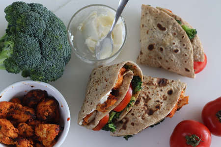 Chicken wraps. Grilled chicken, sauteed broccoli and fresh tomato slices wrapped in a whole wheat...
