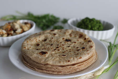 Indian flat bread served along with spicy green garlic condiment and sauteed cottage cheese cubes....