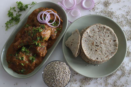 Soft flat bread made of pearl millet flour. Served with chicken in cashew gravy garnished with fresh...