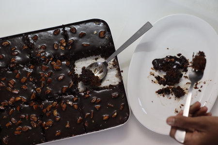 Slice of Texas sheet cake served on a plate. Buttery and chocolaty cake sliced to rectangular pieces...