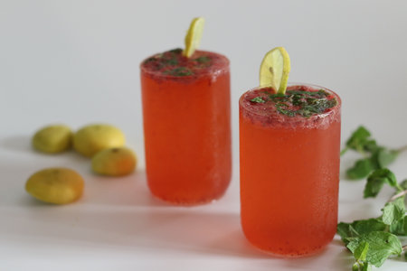 Refreshing strawberry mojito with vibrant colors, mint leaves, lime and ice, perfect for summer...