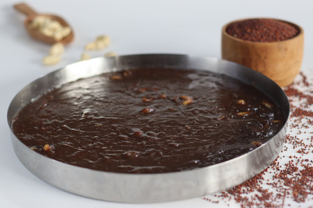Delectable Ragi Halwa in round steel plate mold, Indian dessert, nutritious, vegan, gluten-free,...