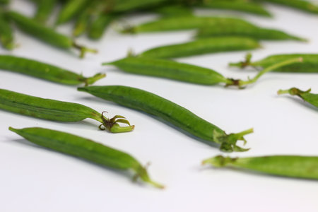 A bunch of fresh green pea pods, showcasing vibrant, organic produce. Perfect for food blogs,...