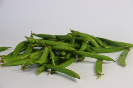 A bunch of fresh green pea pods, showcasing vibrant, organic produce. Perfect for food blogs,...