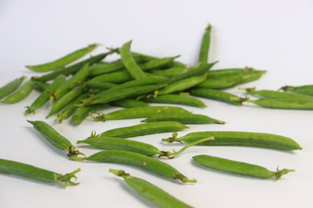 A bunch of fresh green pea pods, showcasing vibrant, organic produce. Perfect for food blogs,...