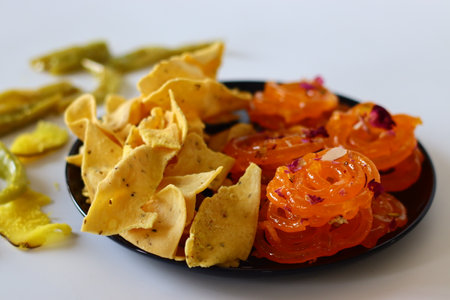 Jalebi with fafda, a beloved combination from Gujarat, India. This sweet and savory duo is a cultural symbol, enjoyed during festivals and celebrations. Perfect for food blogs, and cultural contentの写真素材