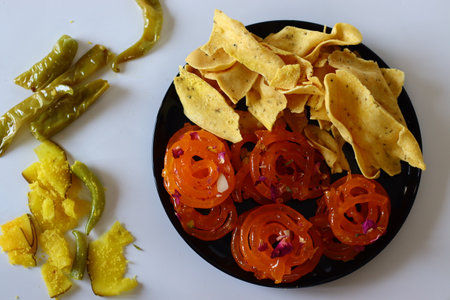 Jalebi with fafda, a beloved combination from Gujarat, India. This sweet and savory duo is a cultural symbol, enjoyed during festivals and celebrations. Perfect for food blogs, and cultural contentの写真素材