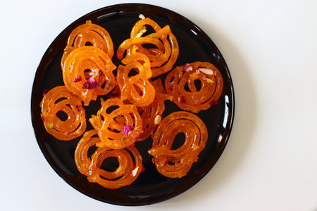 Jalebi, a sweet dish from Gujarat, often paired with fafda. This combination is a cultural symbol of Gujarat, enjoyed during festivals and celebrations. Perfect for food blogs and cultural contentの写真素材