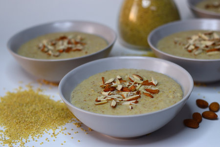 Porridge made of proso millet served in a bowl, topped with chopped badam. A nutritious and wholesome breakfast option, perfect for health-conscious individuals. Ideal for healthy food visualsの写真素材
