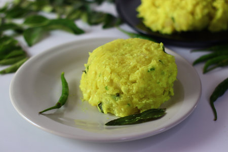 Boiled and mashed tapioca, blended with turmeric and garnished with curry leaves, creating a vibrant...