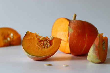 Sliced Orange pumpkin pieces. Vibrant close up of a fresh orange pumpkin with natural textureの写真素材