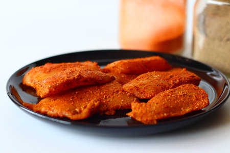 Raw tilapia fillets marinated in a bold Indian spice mix with red chili, turmeric, pepper, and salt,...