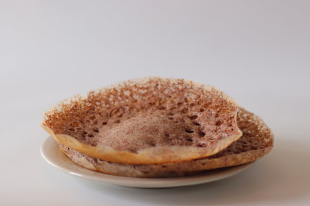Ragi Appam, Freshly cooked Appam with lacy edges and soft center, made from fermented finger millet batter. A wholesome South Indian breakfast rich in calcium, fiber and flavor, perfect healthy foodの写真素材