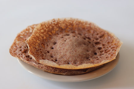 Ragi Appam, Freshly cooked Appam with lacy edges and soft center, made from fermented finger millet batter. A wholesome South Indian breakfast rich in calcium, fiber and flavor, perfect healthy foodの写真素材