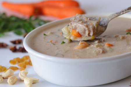 Kerala style mutton stew in a white bowl, made with tender mutton, carrots, coconut milk, curry leaves, and spices. A comforting South Indian dish perfect for festive, traditional, and culinary themesの写真素材