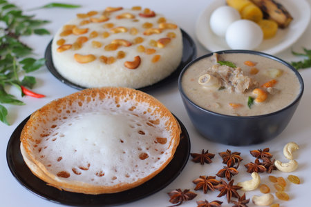 Kerala style breakfast with appam, vattayappam, mutton stew, steamed ethakka, and boiled eggs. A festive South Indian spread styled with spices, curry leaves, and traditional ingredientsの写真素材