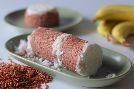Navara rice puttu, cylindrical and dome shaped steamed rice cake with Navara rice grainsの写真素材