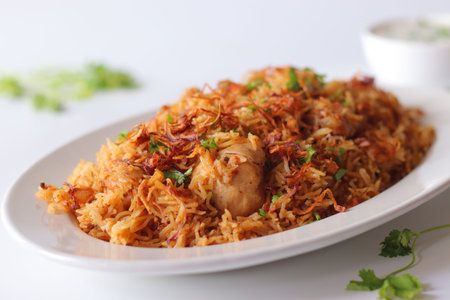 Yakhni pulao with tender chicken, long grain basmati rice, fried onions and fresh herbs. Aromatic...
