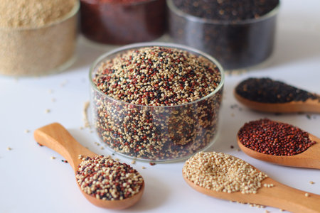 Tricolor quinoa made by mixing white, red and black quinoa seeds. Nutritious gluten free whole grains rich in plant protein and fiber. Healthy superfood for clean eating and balanced dietの写真素材