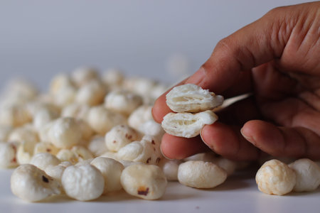 Close up of makhana also known as fox nuts or water lily seeds showing inner texture. Healthy...