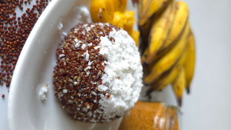 Red quinoa puttu layered with grated coconut and served with sliced Kerala plantain or nendrakaya or...