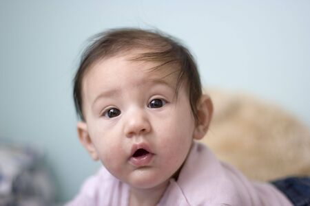 Little baby girl is sweet looking aroundの写真素材