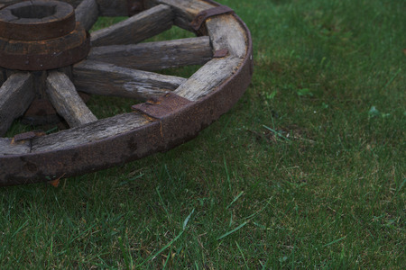 wooden wheel is on a green grassの写真素材