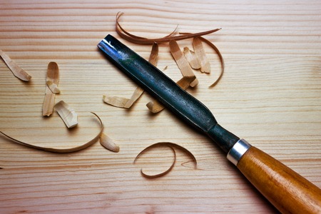 Tool for woodcarving on the table with chips