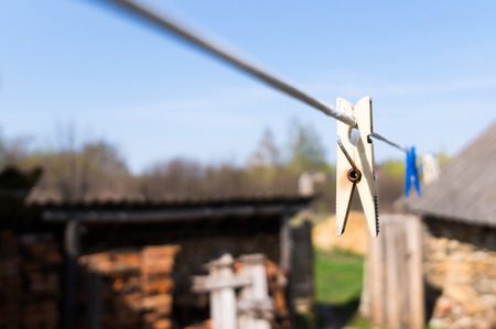 white and blue clothespin on a ropeの写真素材