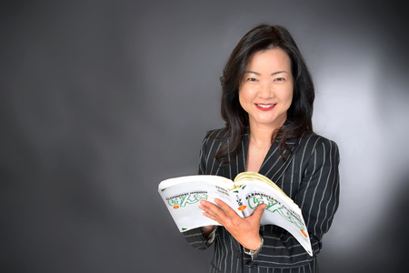 asian teacher holding bookの写真素材