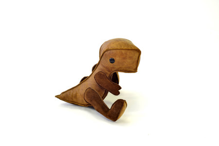 a cute custom handcrafted stuffed leather toy baby dinosaurの写真素材