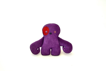 a cute custom handcrafted stuffed leather toy purple creatureの写真素材
